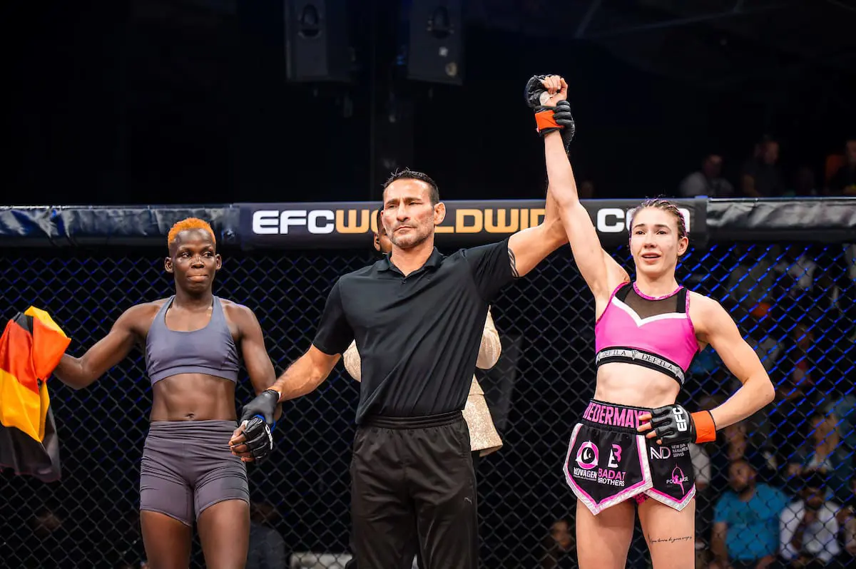 Professional female MMA fighter Ceileigh “Smiley Savage” Niedermayr (wearing pink) in a match against Uganda’s Rebecca “Warrior” Amongi. Picture: EFCWorldWide/Supplied. Professional female MMA fighter Ceileigh “Smiley Savage” Niedermayr (wearing pink) in a match against Uganda’s Rebecca “Warrior” Amongi. Picture: EFCWorldWide/Supplied.
