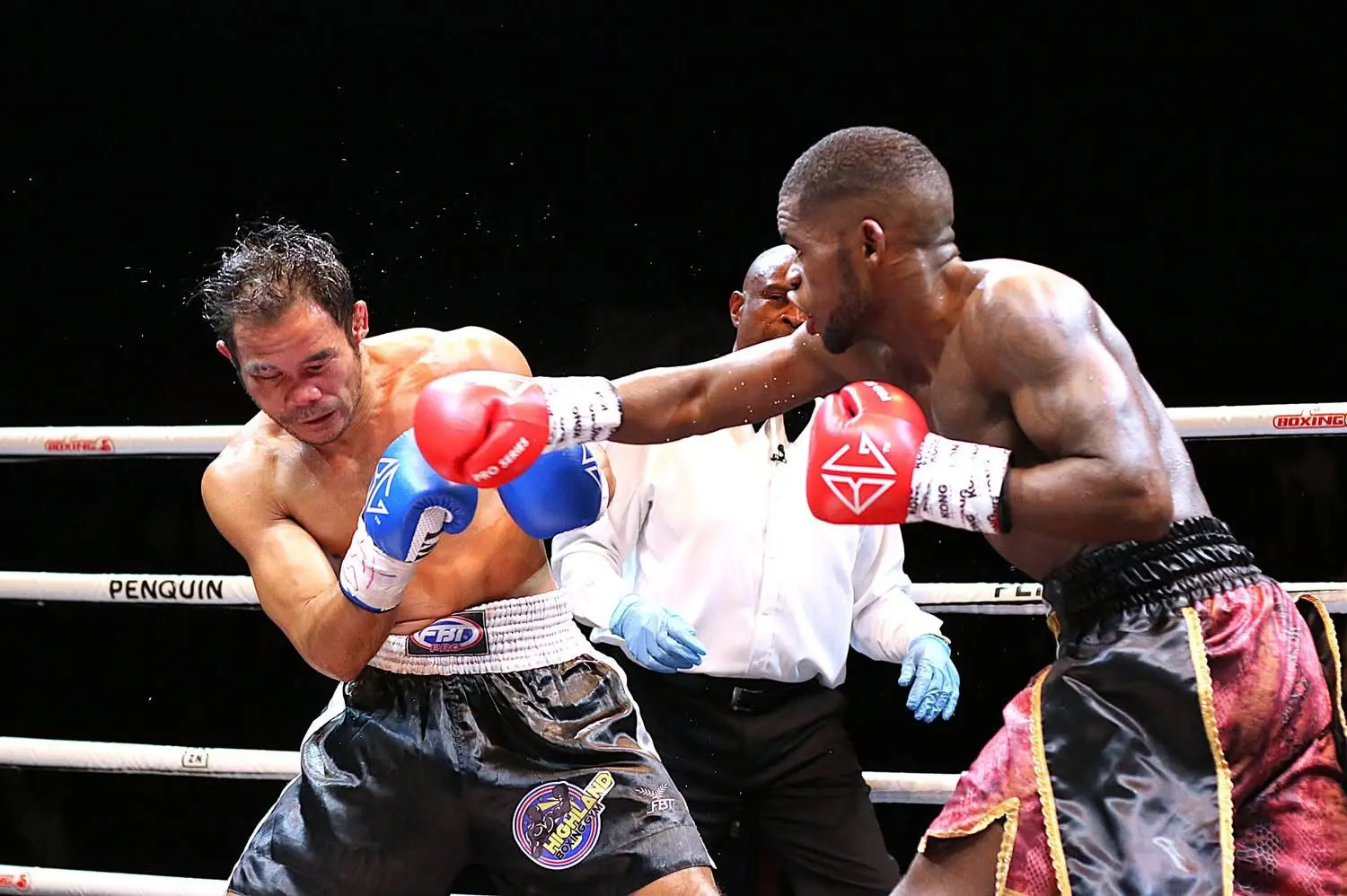 South African featherweight boxer Lerato "Lights Out" Dlamini in the red and black shorts during a fight. Picture: Supplied South African featherweight boxer Lerato "Lights Out" Dlamini in the red and black shorts during a fight. Picture: Supplied