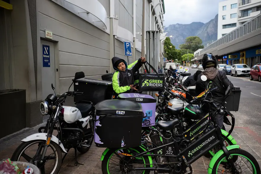 Pitcher makes another delivery from the Claremont hub outside Cavendish Square where she bases herself waiting for orders through the Uber Eats App. Picture: David Harrison/@GroundUp News Pitcher makes another delivery from the Claremont hub outside Cavendish Square where she bases herself waiting for orders through the Uber Eats App. Picture: David Harrison/@GroundUp News