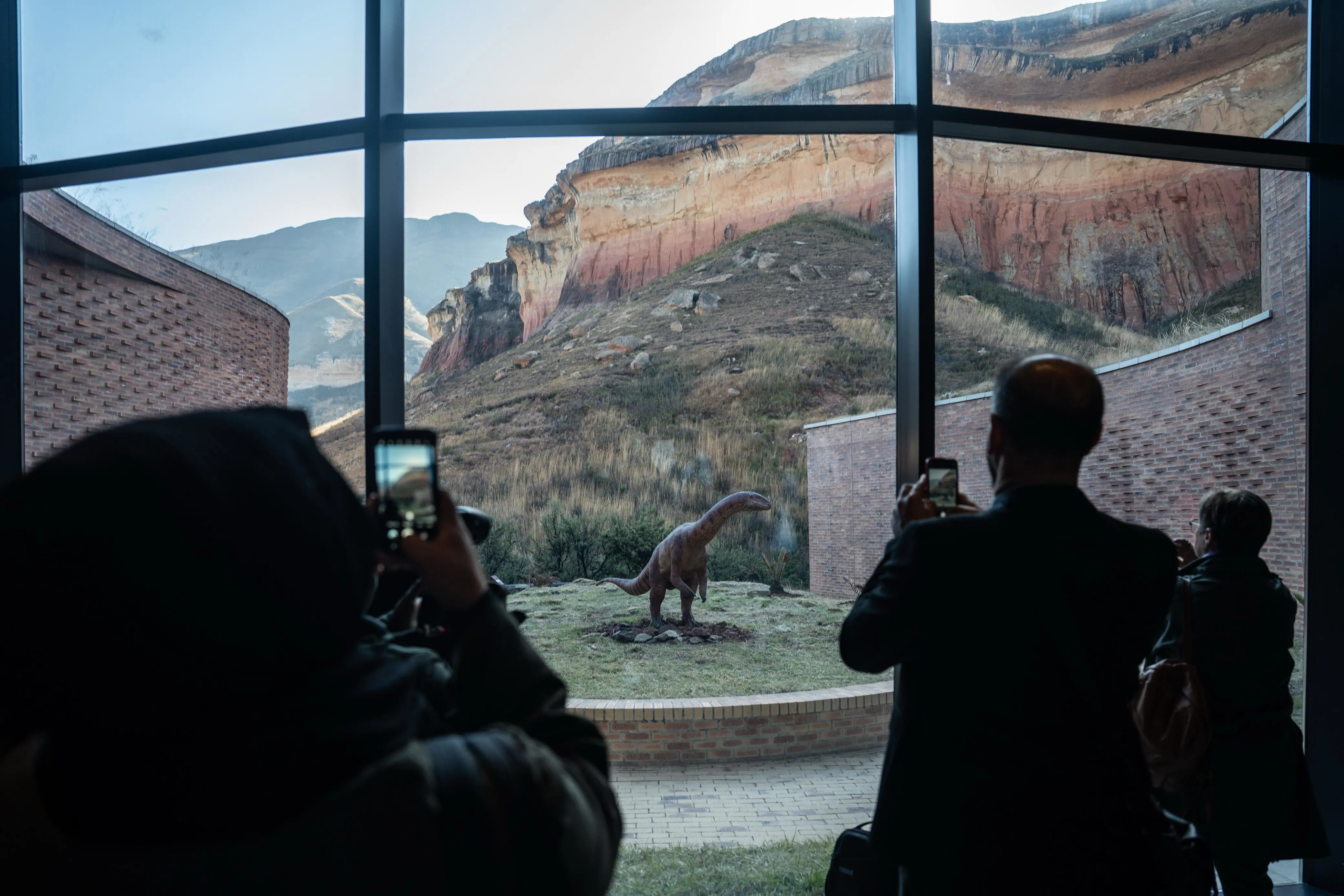 Visitors take pictures of an artist’s reconstruction model of a ‘Massospondylus’, South Africa’s most famous dinosaur on display at the Kgodumodumo Dinosaur Interpretation Centre, located in SANParks’ Golden Gate Highlands National Park in the Free State, on 22 June 2025. Picture: Jacques Nelles/EWN Visitors take pictures of an artist’s reconstruction model of a ‘Massospondylus’, South Africa’s most famous dinosaur on display at the Kgodumodumo Dinosaur Interpretation Centre, located in SANParks’ Golden Gate Highlands National Park in the Free State, on 22 June 2025. Picture: Jacques Nelles/EWN