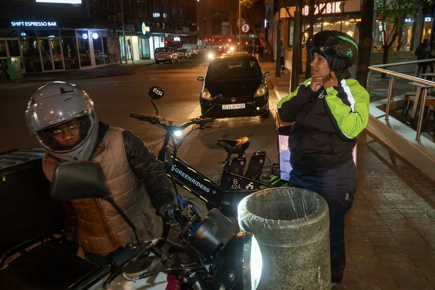 Pitcher (right) gears up to make the 10km ride back to her home in Manenberg after a long day of making deliveries for Uber Eats in the Claremont area. Picture: David Harrison/@GroundUp News Pitcher (right) gears up to make the 10km ride back to her home in Manenberg after a long day of making deliveries for Uber Eats in the Claremont area. Picture: David Harrison/@GroundUp News