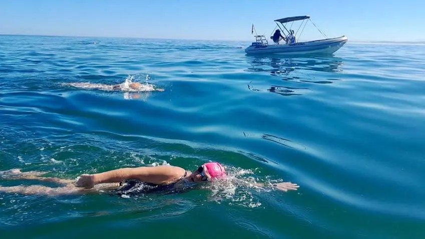 Midway through the challenge, Karen Kennedy pushes on through cold, shifting currents with her swimming partner, Graham du Toit, by her side. Picture: Supplied Midway through the challenge, Karen Kennedy pushes on through cold, shifting currents with her swimming partner, Graham du Toit, by her side. Picture: Supplied