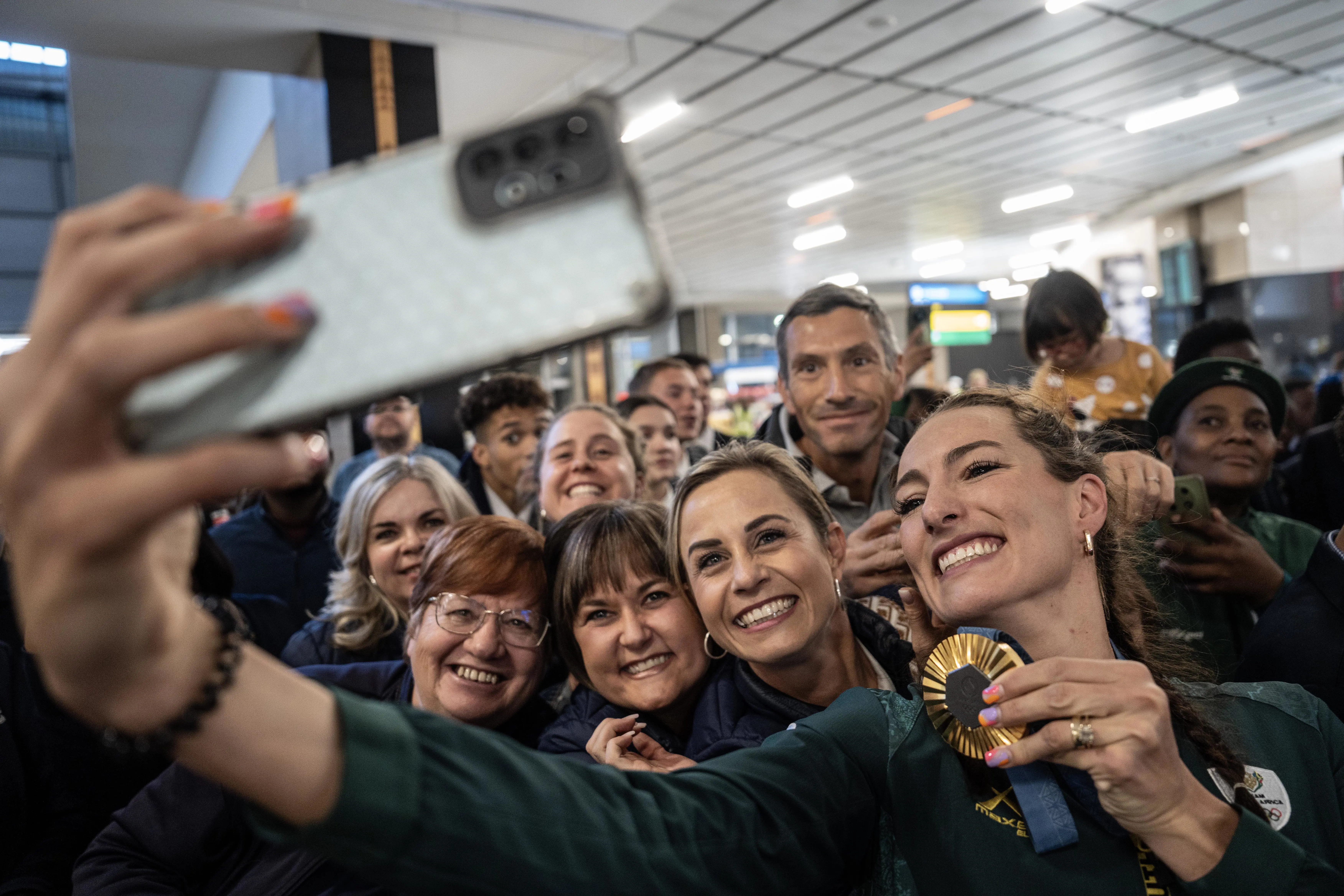 Gold Olympic medallist Tatjana Smith takes a selfie with fans at OR Tambo International Airport Photo: Jacques Nelles/Eyewitness News Gold Olympic medallist Tatjana Smith takes a selfie with fans at OR Tambo International Airport Photo: Jacques Nelles/Eyewitness News