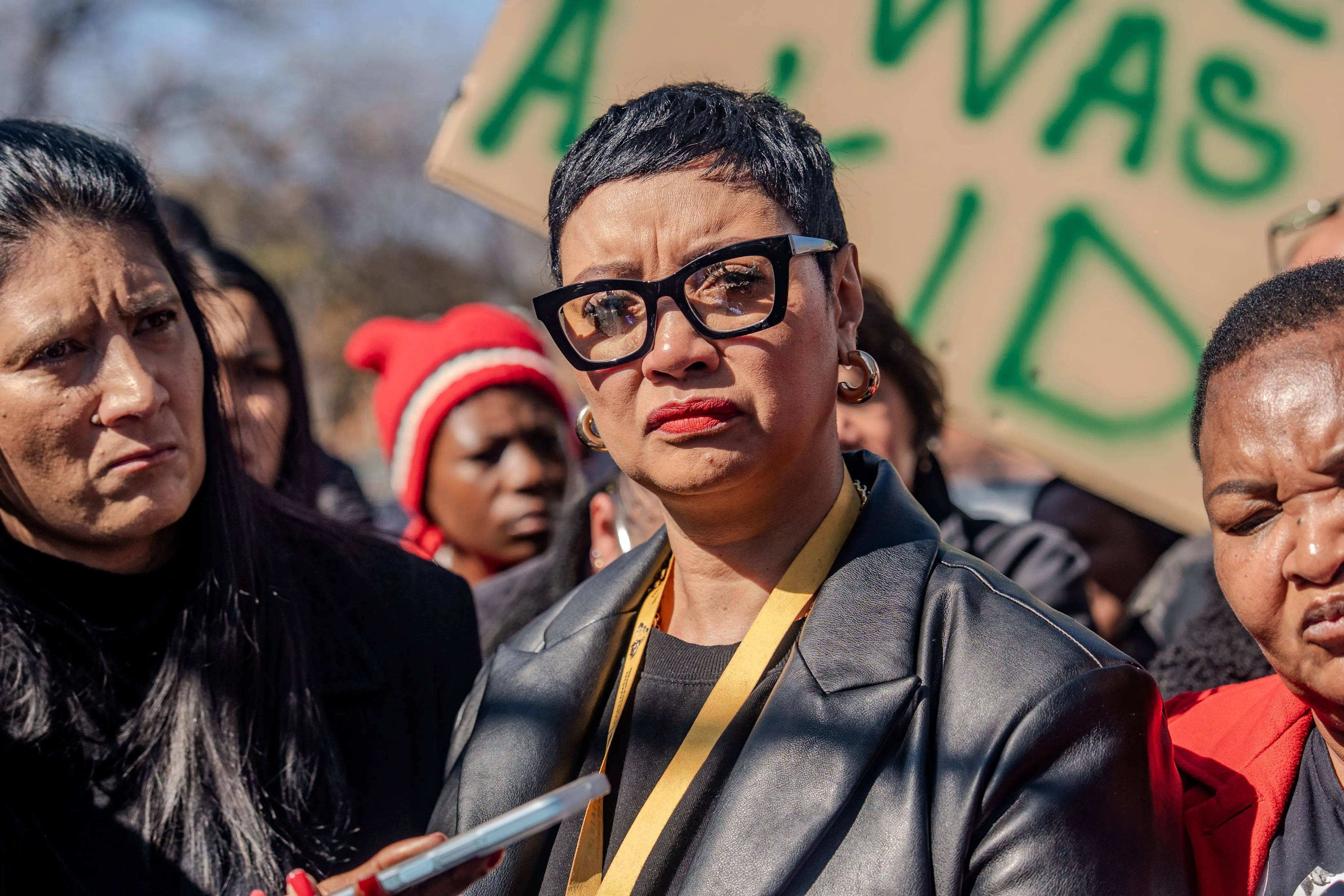 Action SA member of the National Assembly and community activist, Dereleen James, standing amongst the community members protesting outside Roodepoort Magistrates' Court on 14 July 2025. Picture: Sphamandla Dlamini/EWN Action SA member of the National Assembly and community activist, Dereleen James, standing amongst the community members protesting outside Roodepoort Magistrates' Court on 14 July 2025. Picture: Sphamandla Dlamini/EWN