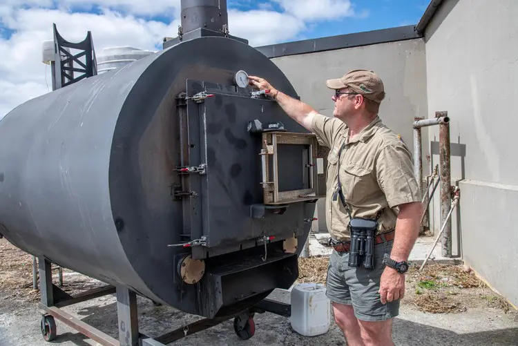Nuwejaars River Nature Reserve operations manager Ross Kettles with the pyrolysis machine that converts invasive alien plant material into agriculturally useful biochar. Picture: John Yeld/@GroundUp News Nuwejaars River Nature Reserve operations manager Ross Kettles with the pyrolysis machine that converts invasive alien plant material into agriculturally useful biochar. Picture: John Yeld/@GroundUp News