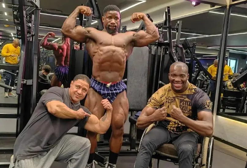 Wheelchair bodybuilder Macethandile "Max" Kulati, Coach Lionel Harker and bodybuilder Lloyd Gobelani flexing at the gym. Picture: Ibff Pro Max/ Facebook. Wheelchair bodybuilder Macethandile "Max" Kulati, Coach Lionel Harker and bodybuilder Lloyd Gobelani flexing at the gym. Picture: Ibff Pro Max/ Facebook.