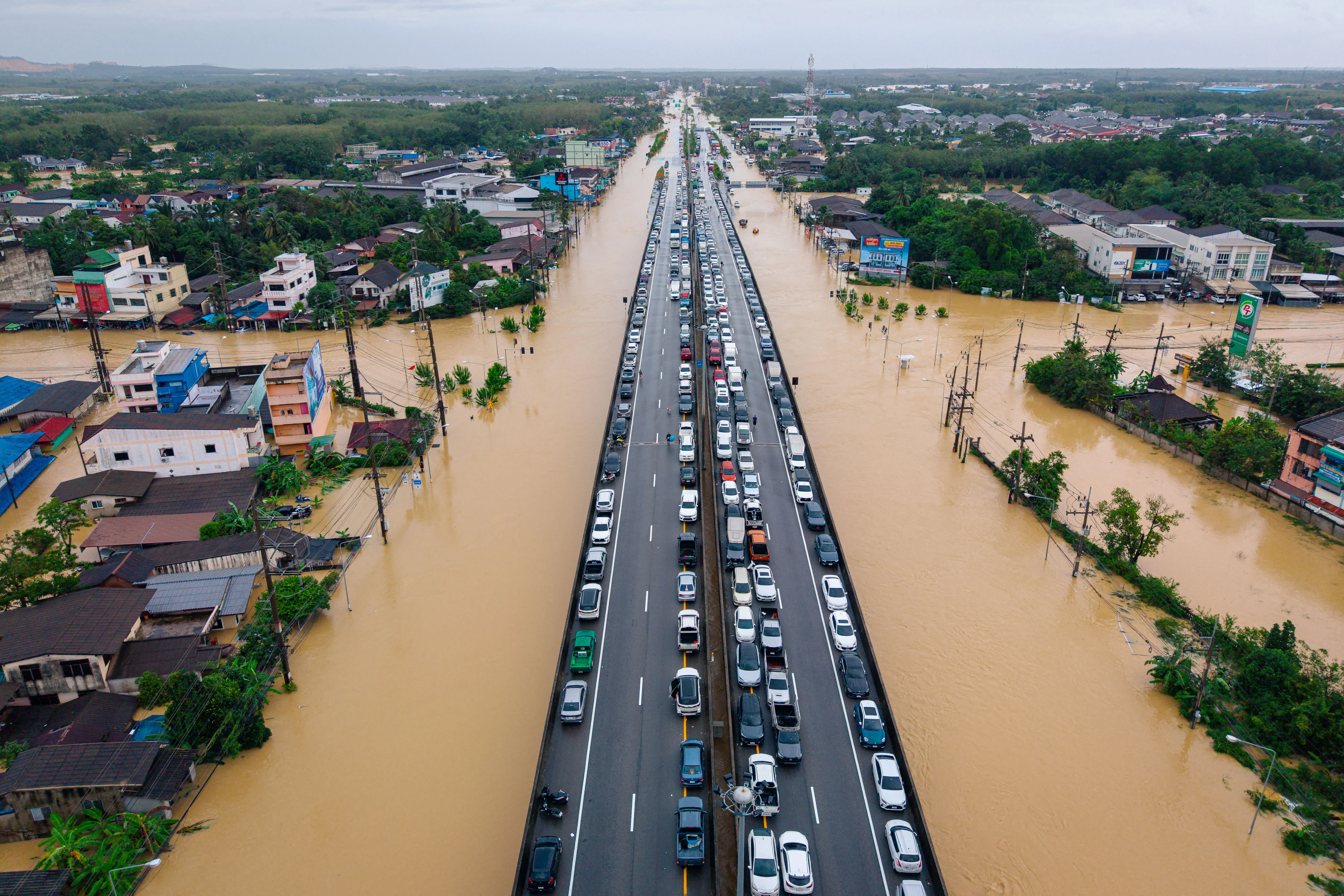 This aerial photo taken on 25 November 2025 shows vehicles parked on an elevated road to keep them out of flood waters in Hat Yai in Thailand's southern Songkhla province, as severe flooding affected thousands of people in the country's south following days of heavy rain. Picture: Arnun Chonmahatrakool / THAI NEWS PIX / AFP This aerial photo taken on 25 November 2025 shows vehicles parked on an elevated road to keep them out of flood waters in Hat Yai in Thailand's southern Songkhla province, as severe flooding affected thousands of people in the country's south following days of heavy rain. Picture: Arnun Chonmahatrakool / THAI NEWS PIX / AFP