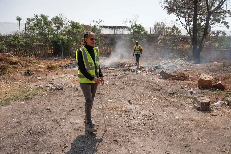 Minah Funani (left) with Phillip Masitenyane (right) at a waste collection site at the back of a local school. Picture: Ihsaan Haffejee/GroundUp Minah Funani (left) with Phillip Masitenyane (right) at a waste collection site at the back of a local school. Picture: Ihsaan Haffejee/GroundUp