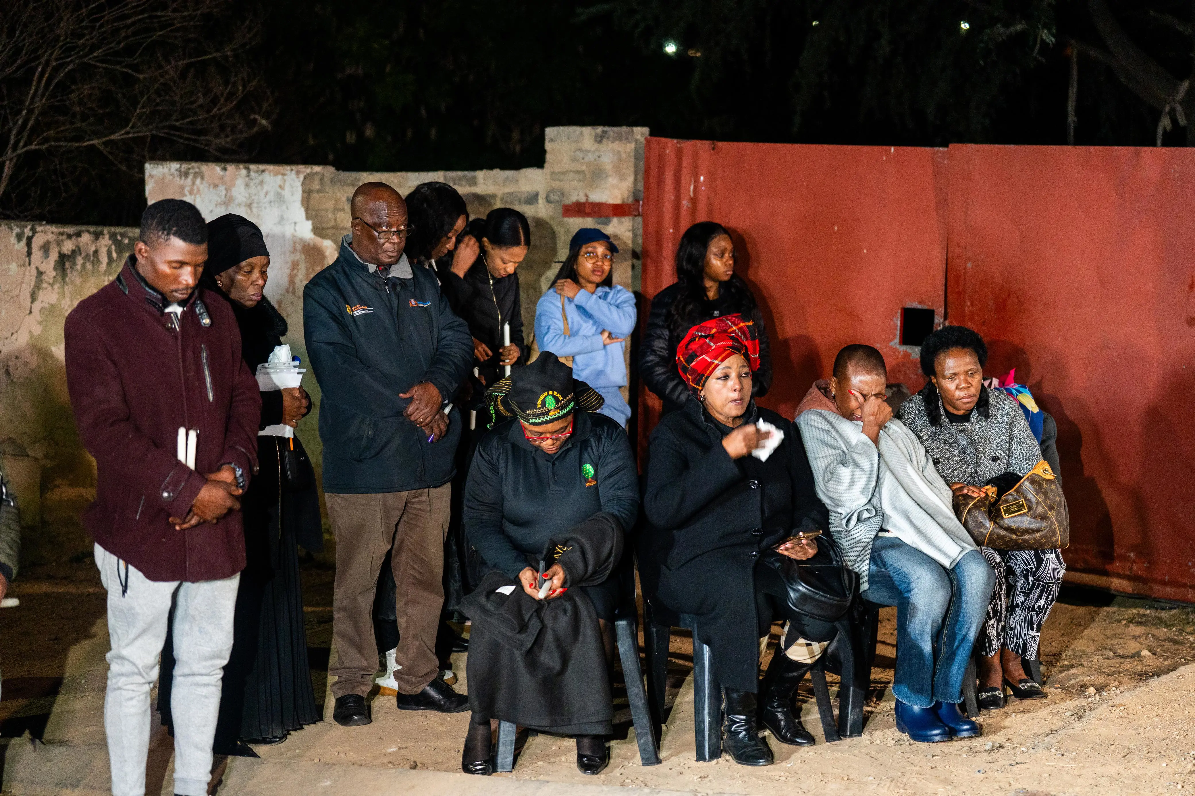 Family members during a candlelight service for Olorato Family members during a candlelight service for Olorato
