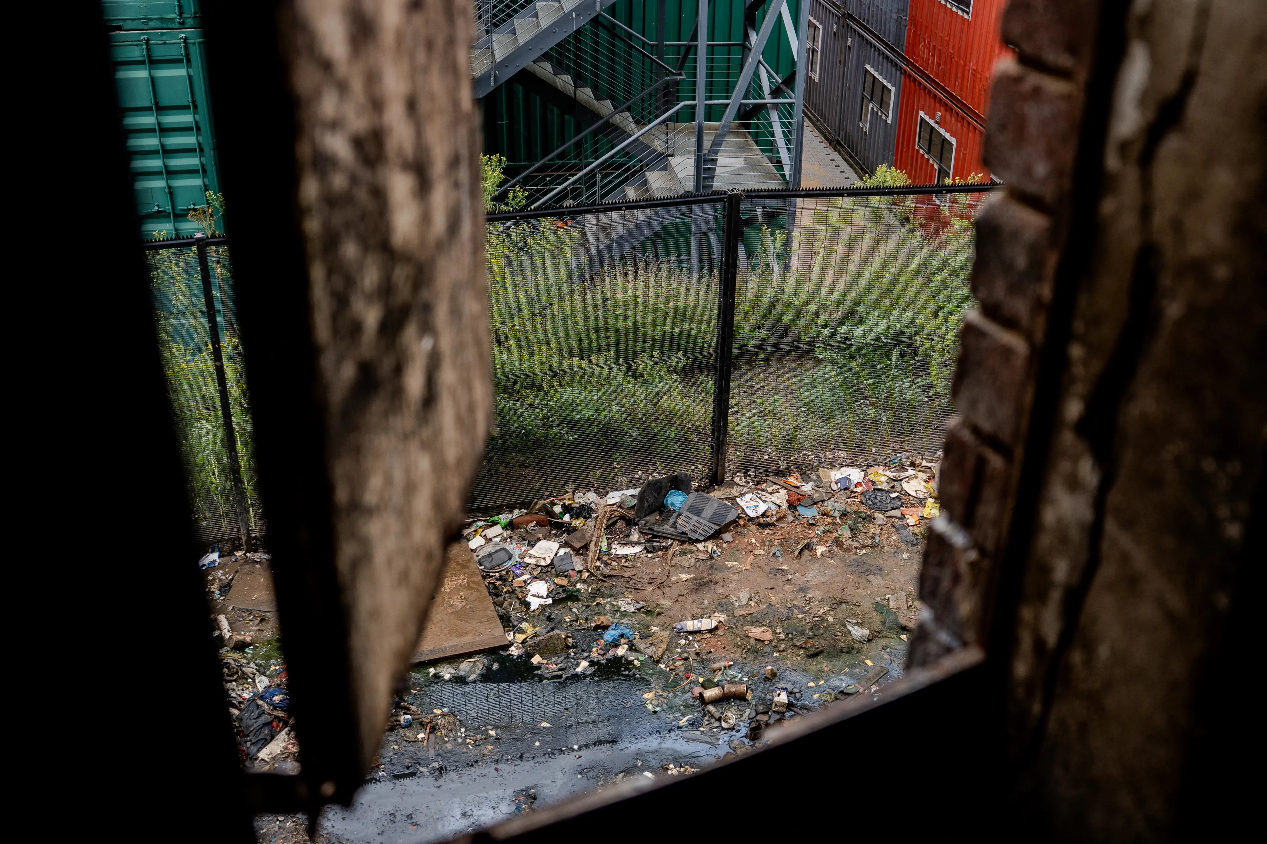 A top view from a kitchen window reveals a heap of dumped waste — an unsettling sight in a building where residents still cook daily meals just steps away. Photo: Sphamandla Dlamini/EWN A top view from a kitchen window reveals a heap of dumped waste — an unsettling sight in a building where residents still cook daily meals just steps away. Photo: Sphamandla Dlamini/EWN