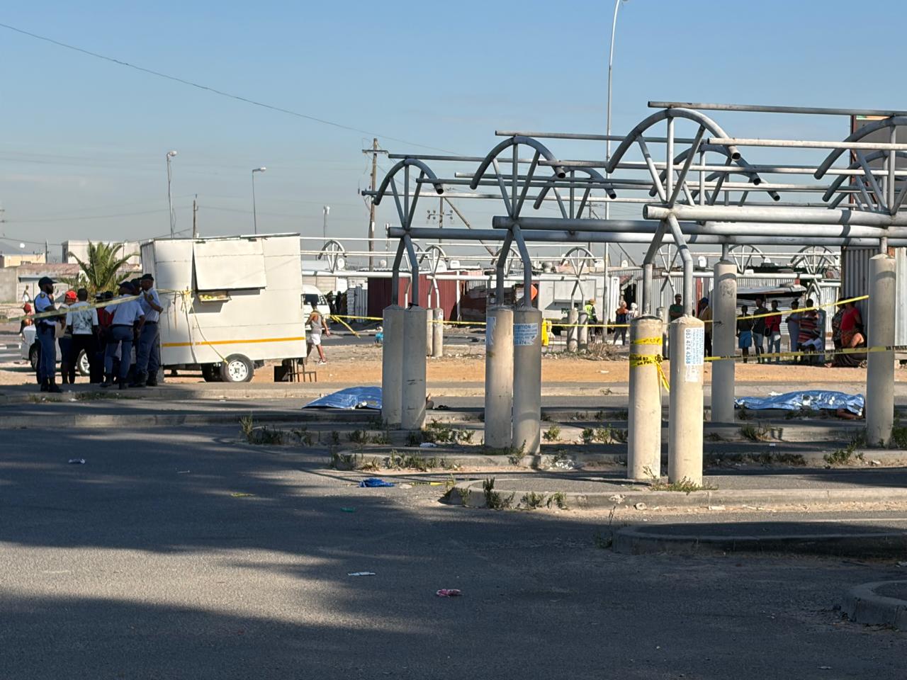 Archive documentary photograph of police activity at a Delft taxi rank following an earlier shooting in March 2026